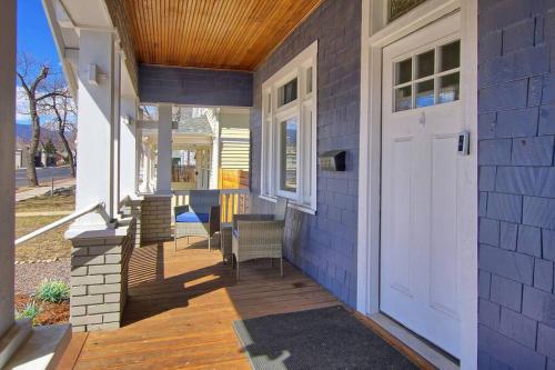 a porch with a white door on a house at Historic Home w/Pikes Peak Views in Colorado Springs