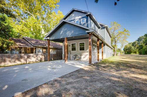 a house with a gambrel roof and a driveway at Pet-Friendly Tomball Home Walk to Main Street! in Tomball