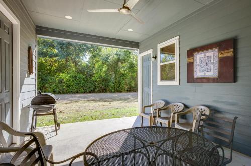a patio with a table and chairs on a porch at Pet-Friendly Tomball Home Walk to Main Street! in Tomball