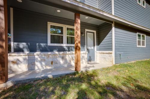 a blue house with a porch and a door at Pet-Friendly Tomball Home Walk to Main Street! in Tomball