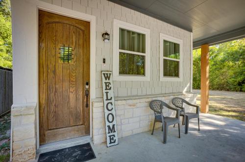 a porch with two chairs and a wooden door at Pet-Friendly Tomball Home Walk to Main Street! in Tomball