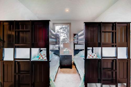 a bedroom with two bunk beds and a window at The Plaza Condominiums by Crested Butte Mountain Resort in Mount Crested Butte