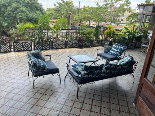 two chairs and a table on a patio at La Villa Saint Jean in Cotonou