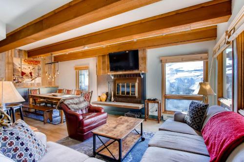 a living room with a couch and a table at The Plaza Condominiums by Crested Butte Mountain Resort in Mount Crested Butte