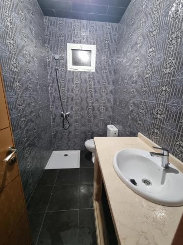 a bathroom with a sink and a shower at Appart tranquille au centre de marrakech in Marrakesh