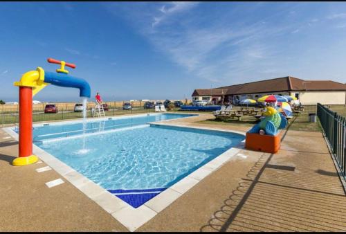 a swimming pool with a water park with a water slide at Platinum Holiday Home by the Sea in Whitstable