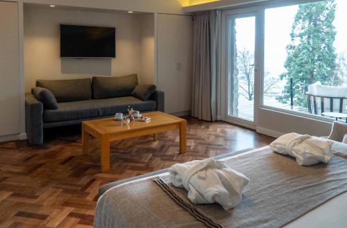 a living room with two beds and a couch at La Cascada Casa Patagónica by DON in San Carlos de Bariloche