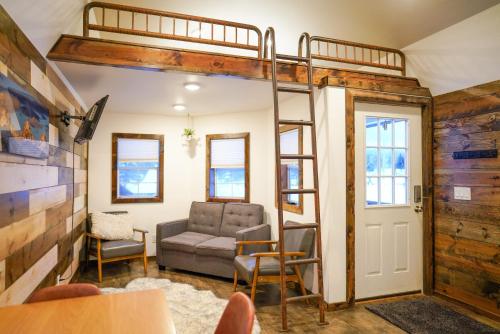 a room with a loft bed and a living room at Teton Tiny Home in Victor