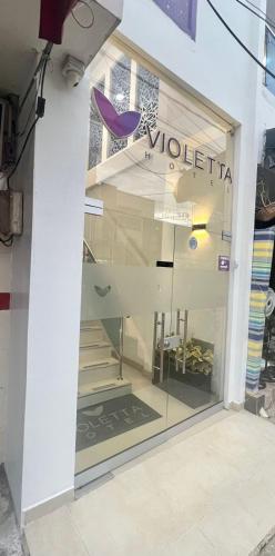 a window of a clothing store with stairs in it at HOTEL VIOLETTA Cereté in Cereté