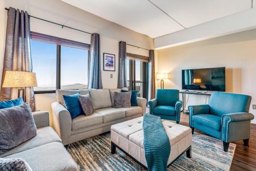a living room with couches and chairs and a tv at Highland Holiday in Sugar Mountain