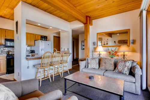 a living room with a couch and a table at The Plaza Condominiums by Crested Butte Mountain Resort in Mount Crested Butte