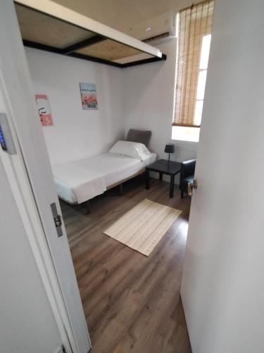 a room with a bed and a room with a door at Alanta Apartments in Madrid