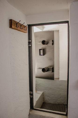 a mirror on a wall in a room with stairs at Vojenský bunker in Bratislava