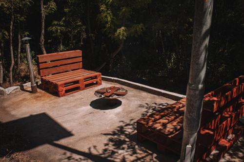 a wooden bench sitting on top of a patio at Vojenský bunker in Bratislava