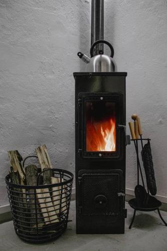 a black stove with a fire in a basket at Vojenský bunker in Bratislava