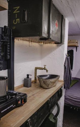 a kitchen counter with a sink and a stove at Vojenský bunker in Bratislava