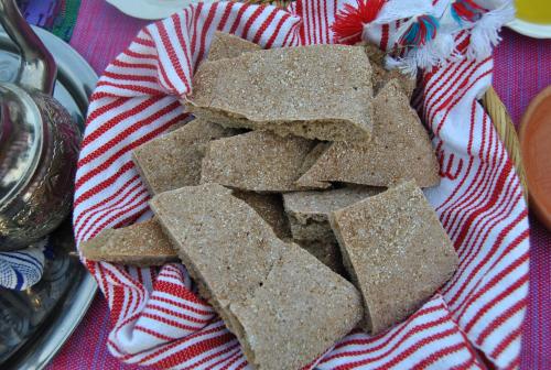 a pile of crackers on a red and white towel at Ferme Dar Aicha green Bellouta in Bellouta