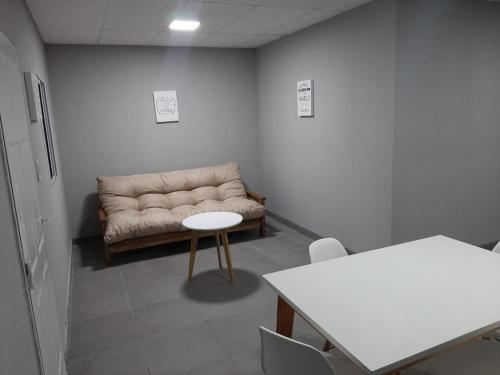 a waiting room with a couch and a table at Departamento Belen in Santa Rosa