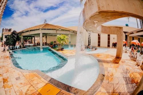 een zwembad in een resort met een fontein bij DiRoma Exclusive in Caldas Novas