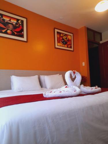 a hotel room with two beds with towels on them at HOSTAL CASA INKAS in Cusco