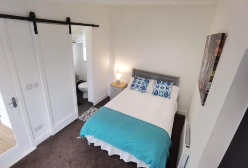 a small bedroom with a bed and a mirror at The Snug in Letterkenny