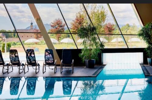 a group of chairs sitting next to a swimming pool at Holiday Apartment Murtal in Judenburg