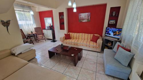 a living room with a couch and a tv at Modern Sea Villa in Leptokaria in Leptokaria