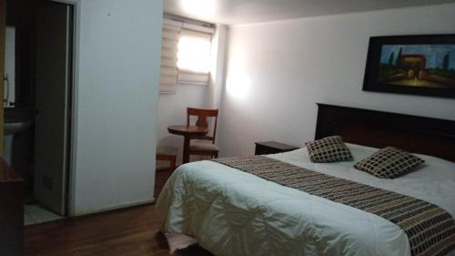 una camera con un letto con due cuscini sopra di Hotel El Gourmet a La Calera