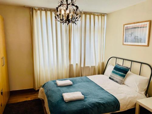 a bedroom with a bed with two towels on it at London Mackenzie Suites in London