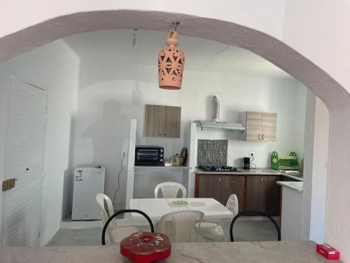 a kitchen and dining room with a table and chairs at Dar El Amel in Mellita