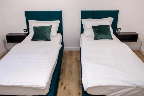 two beds sitting next to each other in a room at Villa Copun with heated pool in Rab