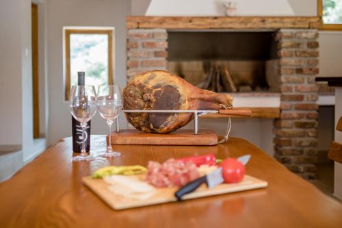 a turkey on a stand on a table with glasses of wine at Villa Copun with heated pool in Rab