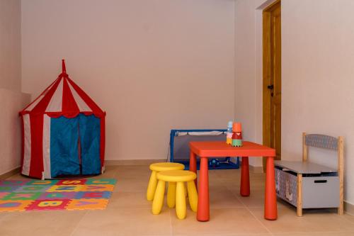 a room with a tent and a table and chairs at Villa Copun with heated pool in Rab