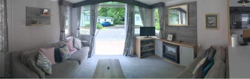 a living room with a couch and a table at Luxury caravan in Porthmadog