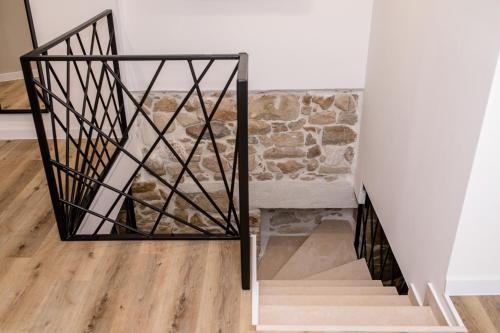 a staircase with a glass and metal railing at Villa Copun with heated pool in Rab