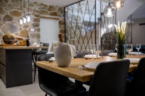 a dining room with a wooden table with chairs at Villa Copun with heated pool in Rab