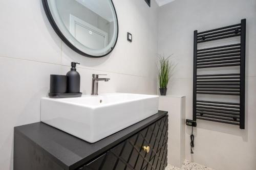 a bathroom with a white sink and a mirror at Villa Copun with heated pool in Rab