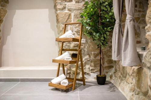 a bathroom with a wooden towel rack with towels at Villa Copun with heated pool in Rab
