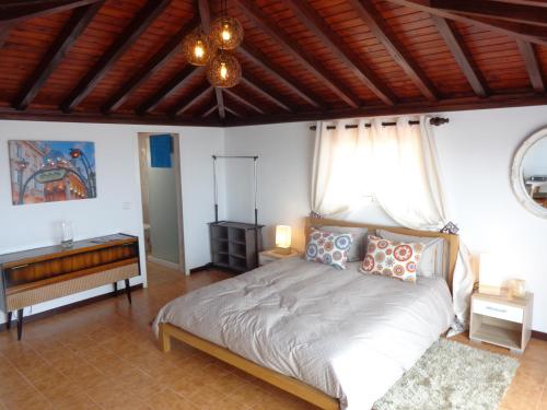 a bedroom with a bed and a wooden ceiling at Madeira Holiday Flats in Funchal
