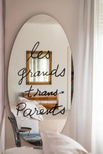 a mirror with a sign that reads hyalls thank rewards at Villa Bonafata b&b in Trieste