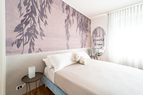 a bedroom with a bed and a large painting on the wall at Villa Bonafata b&b in Trieste