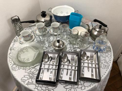a table with a table cloth with plates and glasses at Hermoso Departamento en Belgrano R para 3 personas in Buenos Aires