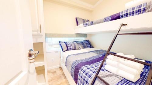 a small bedroom with a bunk bed and a staircase at Point Sebago Resort in Casco