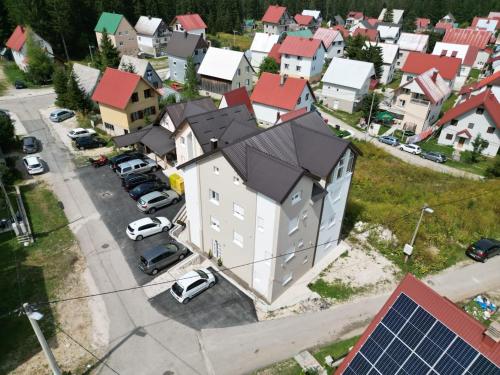 a large house with a black roof in a city at Premium Apartments in Žabljak