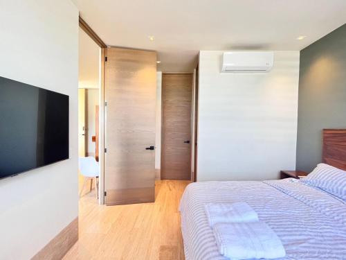 a bedroom with a bed and a sliding door at Condo Gallo in Cozumel