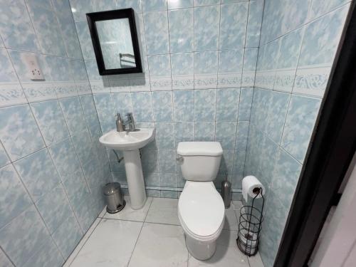 a bathroom with a toilet and a sink at Chalet Belizomi Tropical Villas No #2 in Rodney Bay Village