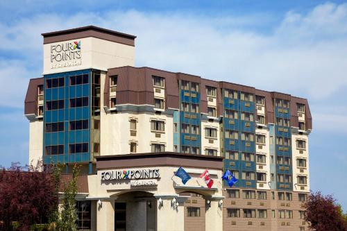 a hotel building with a trumpumps sign on it at Four Points by Sheraton Edmonton South in Edmonton