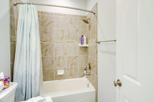 a bathroom with a shower and a white tub at Albuquerque Vacation Rental Less Than 1 Mi to Downtown! in Albuquerque