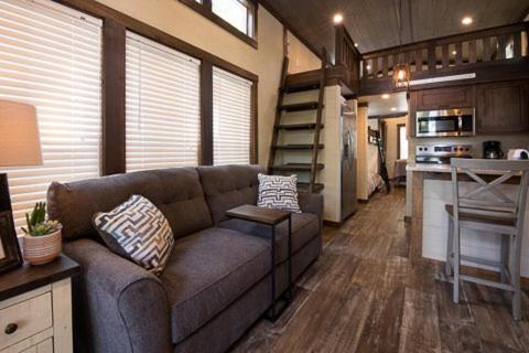 a living room with a couch in a tiny house at Point Sebago Resort in Casco