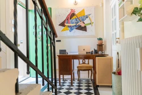 a hallway with a desk with a laptop on a table at Villa Bonafata b&b in Trieste